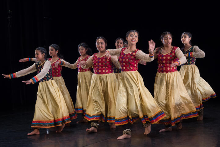 dancers performing in South Asian costume