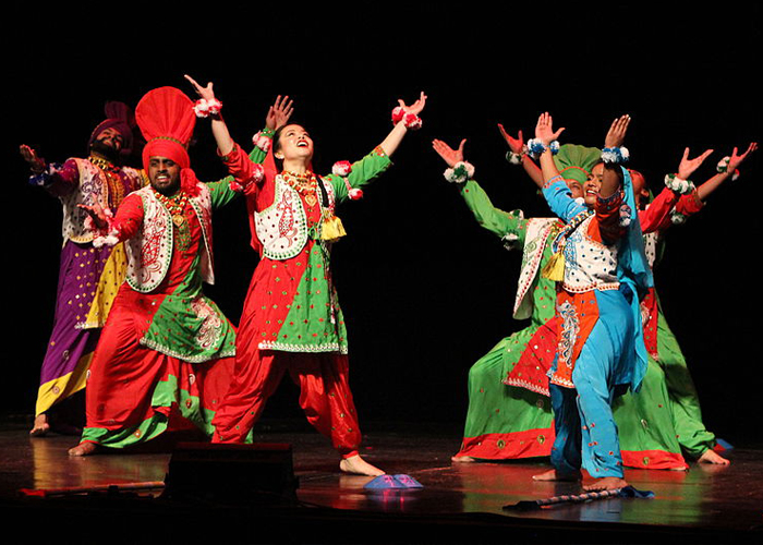 group of South Asian dancers in ornate clothing