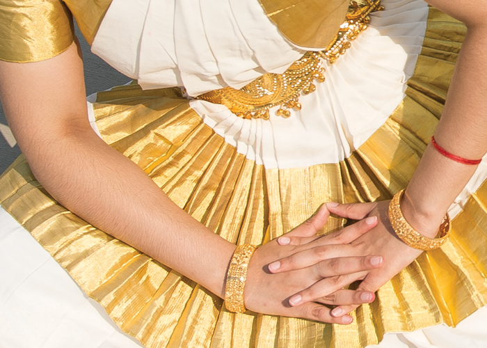 Dancer's hands on gold costume