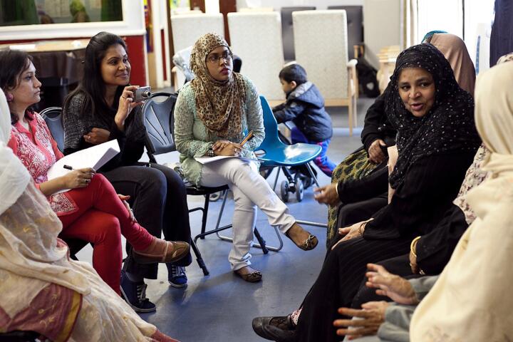 women talk in a circle during a workshop
