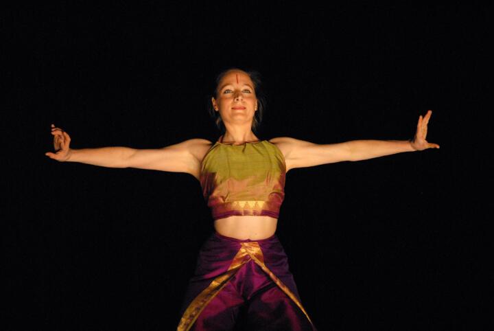 dancer performing with outstretched arms