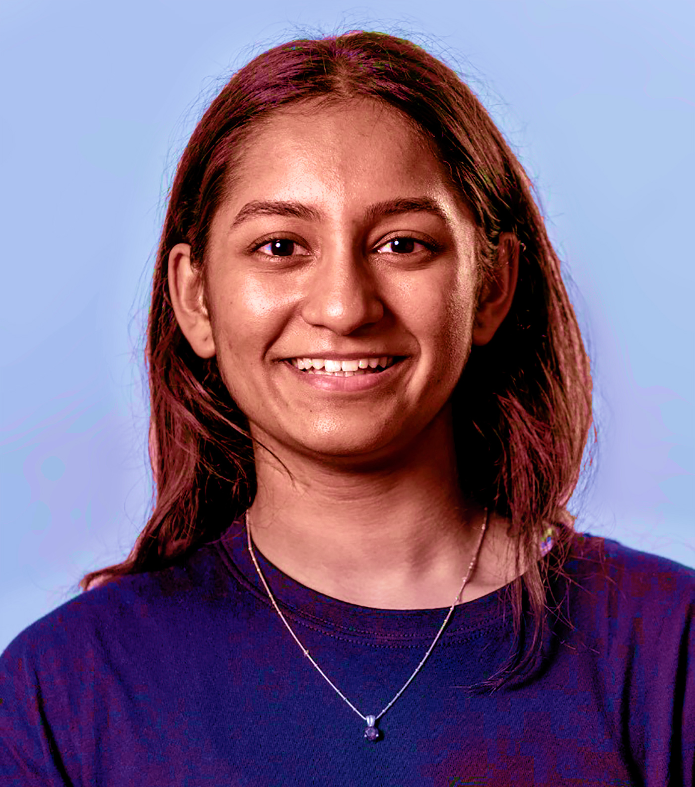 headshot of Adhya Shastry smiling at the camera