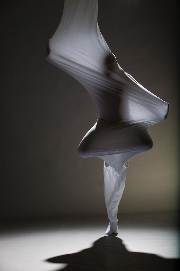 sculptural form of a dancer wrapped in translucent fabric