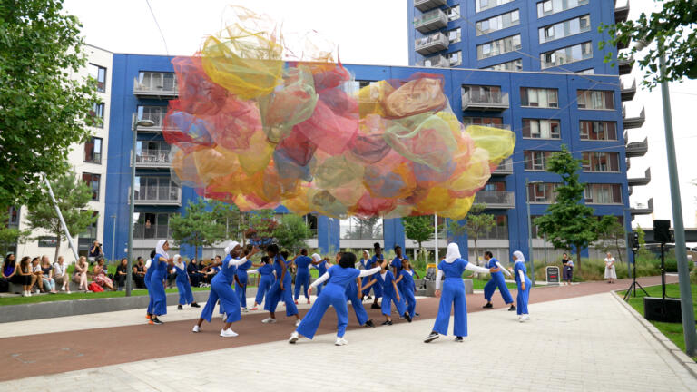 outdoor dance performance with colourful clouds