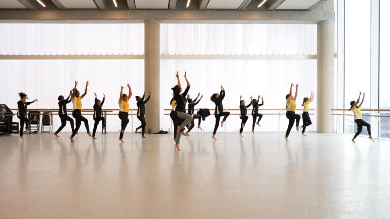 group of dancers in a rehearsal space