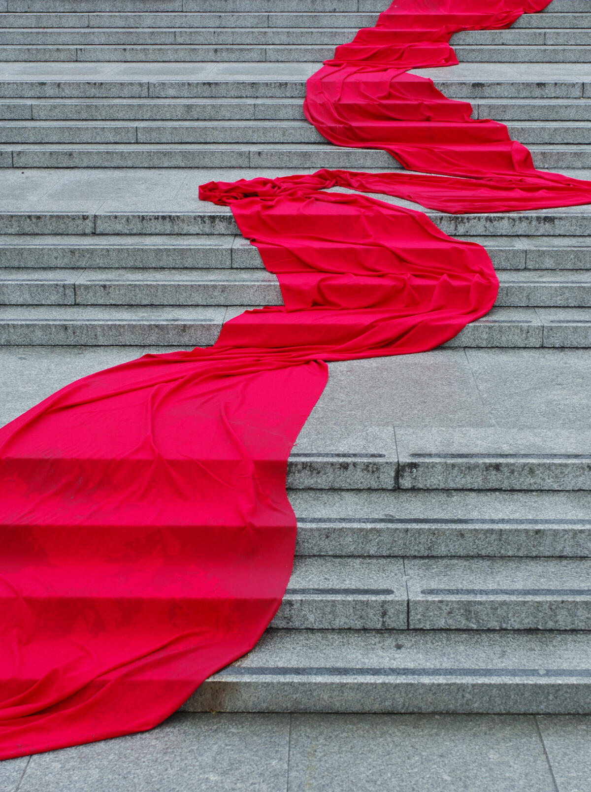red material draped over concrete steps